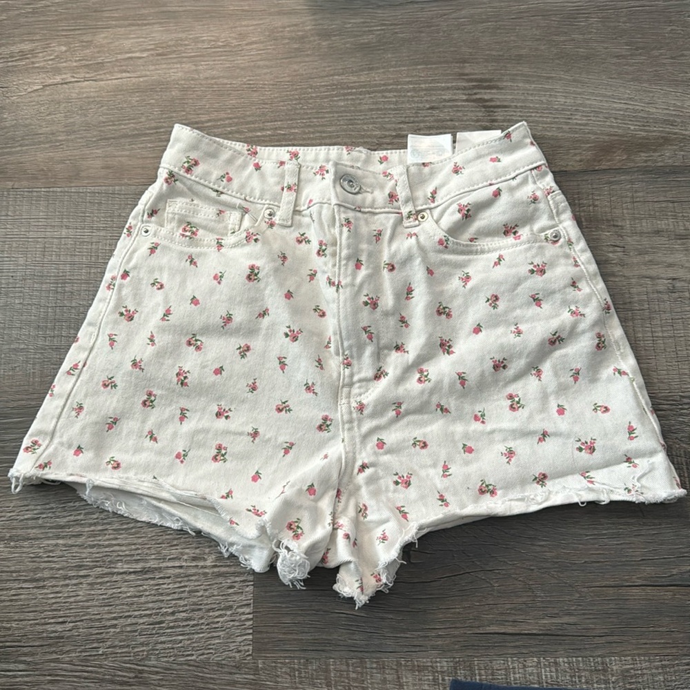 White jean shorts with flowers.